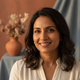 Portrait of a happy South Asian woman smiling serenely, conveying trust and satisfaction.
